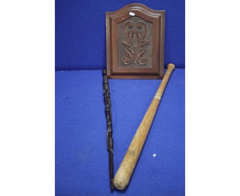 A CARVED WOODEN PANEL TOGETHER WITH A CARVED WALKING STICK AND A BASEBALL BAT