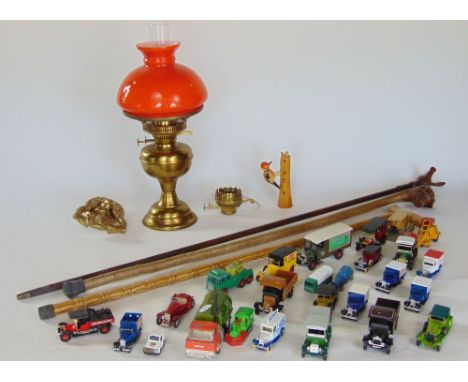 A mixed miscellaneous lot to include a brass oil lamp with orange shade, cast brass door knocker, a collection of die cast to