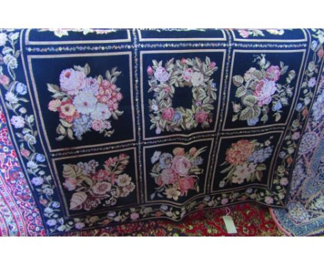 A Belgium wool hanging tapestry of floral panels amidst scrolling foliate borders, 160 x 150 cm approx.