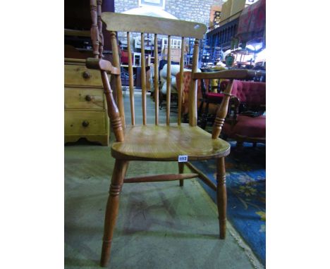 A 19th century Windsor stick back elbow chair with elm seat and beechwood supports with stripped and waxed finish