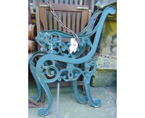 A pair of cast iron bench or seat ends with lion mask and other detail.