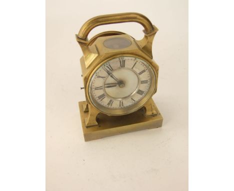 An Arts & Crafts style mantel clock/timepiece, the good quality brass frame of octagonal form with loop handle and shaped fee