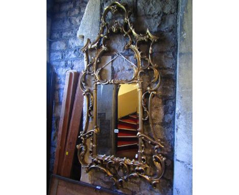 A substantial Chippendale style wall mirror, the bevelled edged mirror plate within a large and ornate gilded frame with C sc