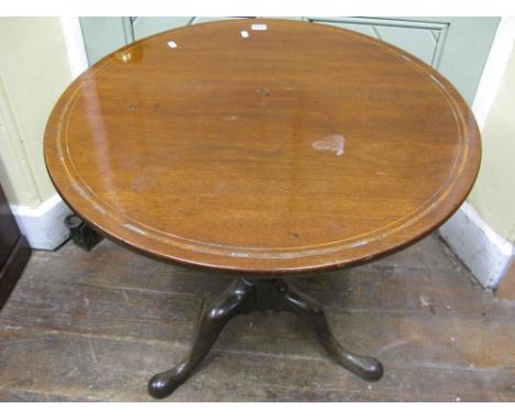 A Georgian mahogany snap top occasional table of circular form with satin wood banding, raised on a turned vase shaped pillar