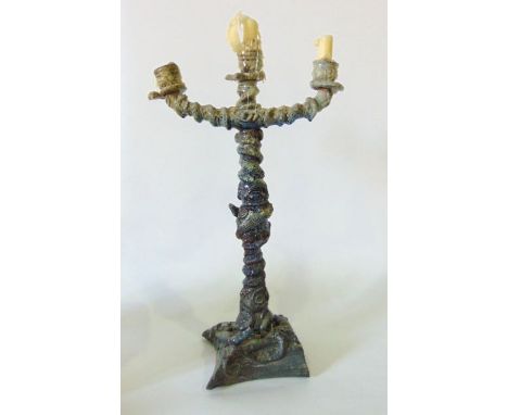 An unusual three tier candelabra in the manner of Palissy of Portugal, the central column decorated with coiled serpents and 