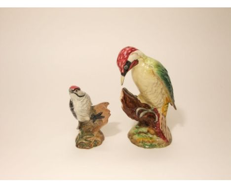 A Beswick model of a woodpecker with impressed number to base 1216, together with a further Beswick model of a lesser spotted