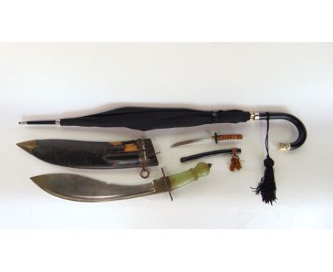 An interesting Khukri with jade type handle together with a further paper knife in the form of a Samurai sword and a parasol 