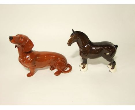A large Beswick model of a recumbent short haired dachshund, with circular printed marks to base, 41cm approx; together with 