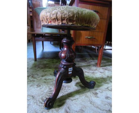 A Victorian mahogany piano stool the circular top with adjustable mechanism raised on a fluted column and three scrolled supp