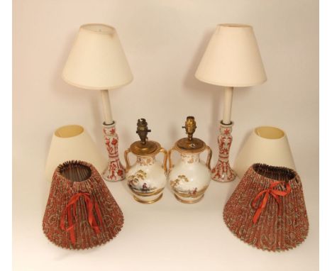 A pair of 19th century cream ground two handled vases with painted decoration of a traveller in a landscape, with further gil