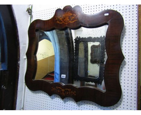A mid-19th century continental rosewood wall mirror with shaped and moulded frame, with boxwood string inlaid detail and flor