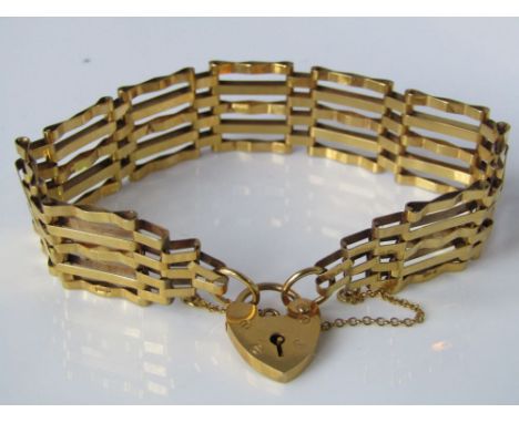 A 9k gold gate link bracelet with a 9k gold heart locket. 10.4g