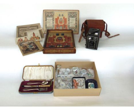 Two boxes of interesting items to include dolls house porcelain, boxed flatware, vintage camera and with original instruction