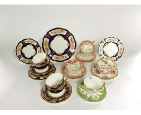 A collection of early 20th century Mintons tea wares with blue and gilt swag border decoration comprising four cups, three sa