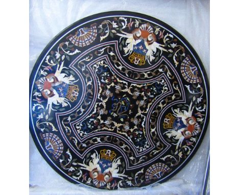 A good quality Pietra Dura circular table top, the black ground decorated geometrically with shells, trailing floral bands, 1