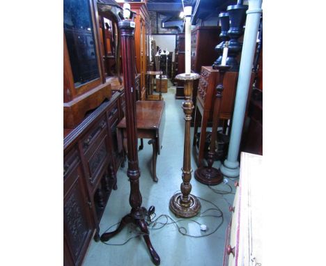 A mahogany standard lamp, the column partially fluted and carved with foliate detail, raised on shaped tripod supports togeth