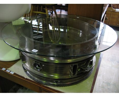 A vintage industrial coffee table, the base an engine turbine reclaimed from an aeroplane with circular glass top, 36 cm high