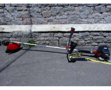 A Kawasaki petrol driven strimmer, Model No KBH 27A.