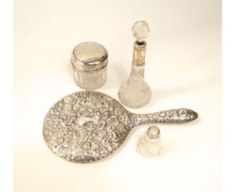 A silver topped cut glass dressing table pot together with two cut glass silver coloured scent bottles and a white metal circ