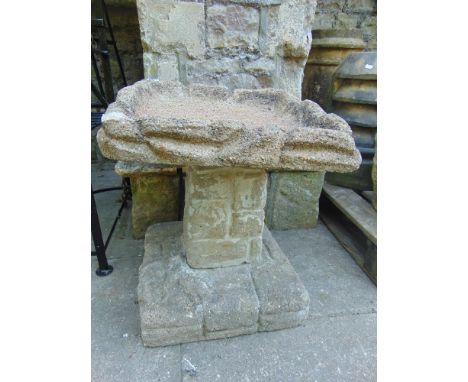 A three sectional reconstituted garden bird bath and an iron sundial.