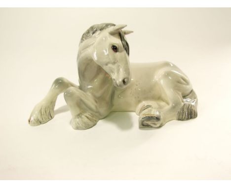 A Beswick model of a recumbent white shire horse with printed circular mark to base, 24cm long approx