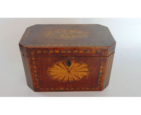 A Georgian mahogany and box wood inlaid tea caddy with canted corners, the hinged lid enclosing a fitted interior, 12 cm high