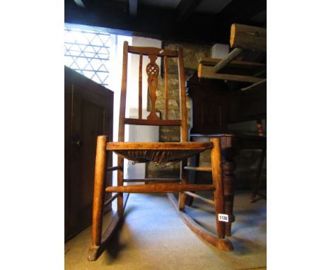 An Edwardian beech wood rocking chair with rush seat, Victorian mahogany hall chair with carved back, a spinning chair and a 