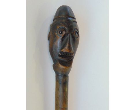 Tribal interest - carved hardwood stick with carved knop in the form of a gentleman.