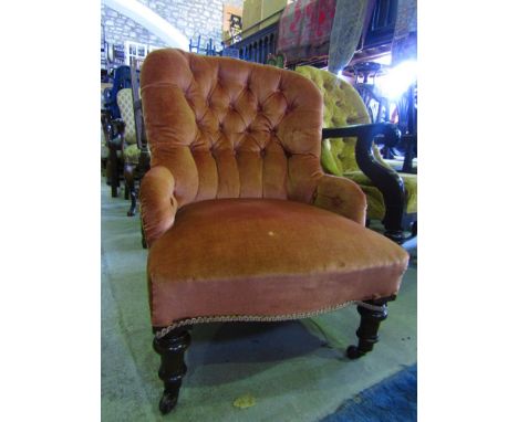A late Victorian drawing room or bedroom chair with velvet upholstery and button back frame on turned supports