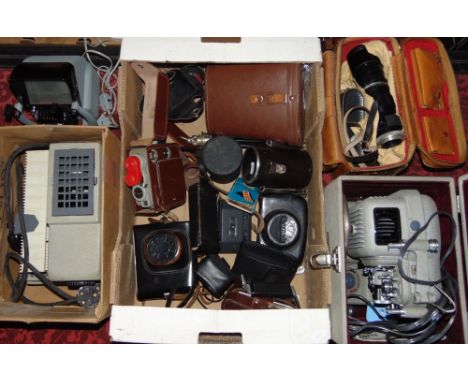 A box containing a collection of camera and projecting equipment to include cameras, lenses and projection equipment