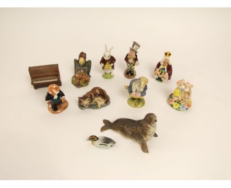 A collection of Beswick Alice in Wonderland figures including White Rabbit, King of Hearts, Mad Hatter, Cheshire Cat and Gryp