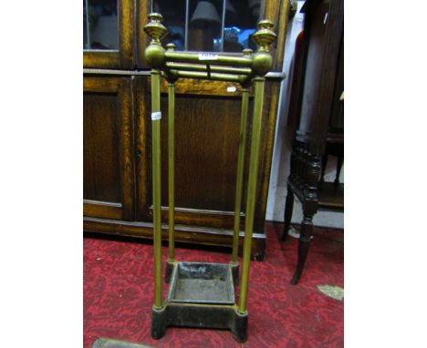 A Victorian iron and brass four divisional stick stand with turned finials.