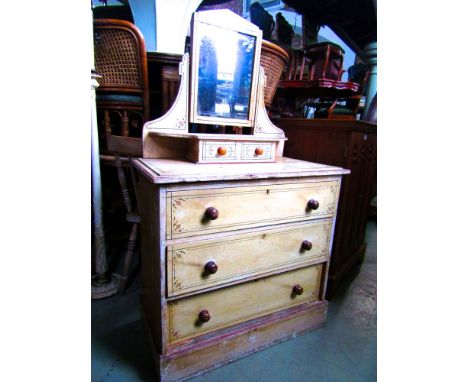 A Victorian stencilled pine dressing chest of three long graduated drawers beneath two trinket drawers with swing mirror over