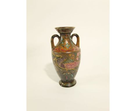 An early 20th century continental two handled vase in the Zsolnay Pecs manner with painted and gilded stylised floral, bird a