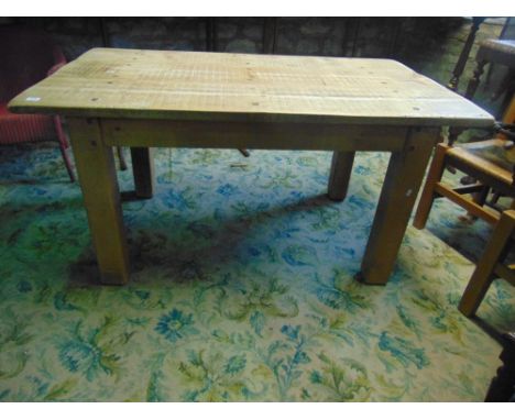 A rustic pine farmhouse table, the heavy plank top raised on four square cut supports together with a set of four beechwood l