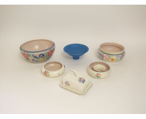 A collection of Poole pottery wares comprising a fruit bowl, further circular bowl, a doughnut shaped posy holder, cheese dis