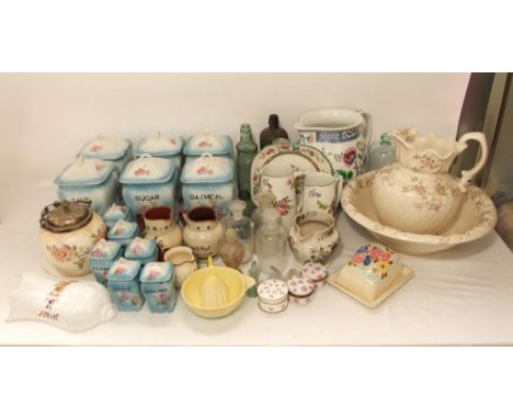 A collection of ceramics including kitchen storage jars and covers with printed floral decoration inscribed coffee, oatmeal, 