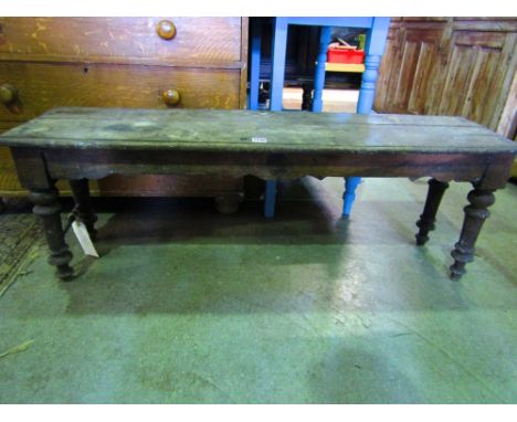 A Victorian oak hall bench with four turned supports beneath a plank top, 122cm long