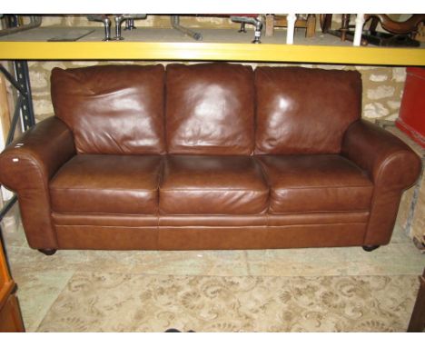 A modern good quality brown leather three seater sofa.