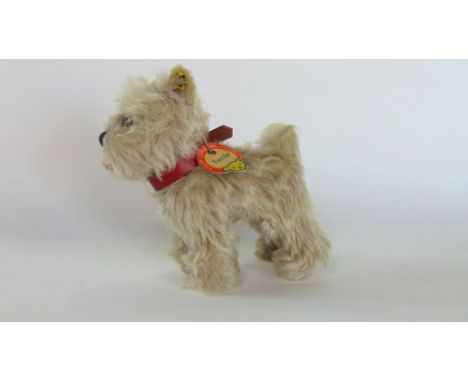 A Stieff mohair stuffed terrier (Tessie) with tag and button in ear.