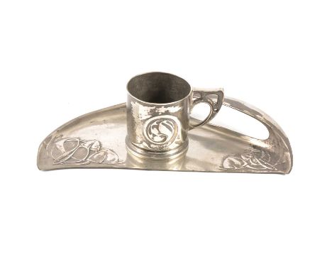 Tudric pewter crumb tray and a mug, designed by Archibald Knox for Liberty &amp; Co, the tray with cast Celtic knots with sty