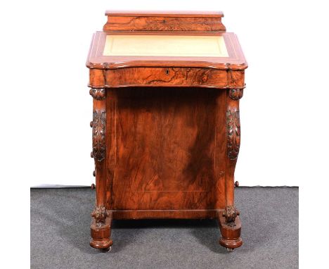 Victorian walnut Davenport desk, domed top enclosing compartments, sloping leather writing surface with carved and scrolled s