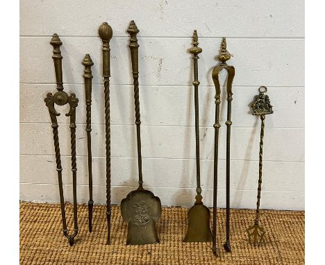 A selection of brass fireside tools 