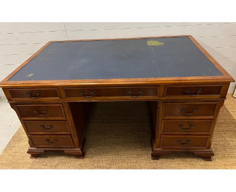 A Pedestal desk with leather top on bracket feet 