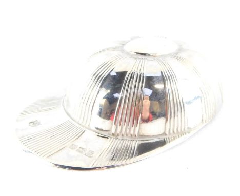 An Edward VII silver caddy spoon, modelled as a jockey's cap, with engraved fluted decoration, monogram engraved, Thomas Brad