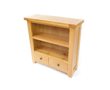 A light oak open bookcase, of two shelves over a pair of frieze drawers, raised on block feet, 90cm high, 90cm wide, 32cm dee