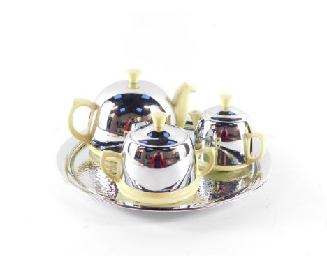 A mid century Heatmaster four piece tea set, yellow glazed with chrome covers, comprising circular tray, teapot, milk jug and