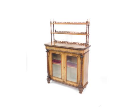 A Victorian walnut chiffonier display cabinet, the top with two open shelves, raised on fluted and turned columns, over a pai