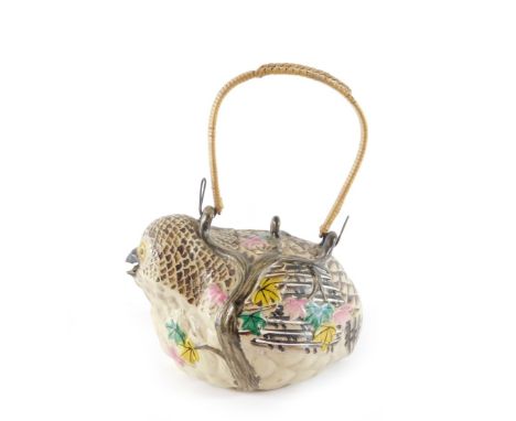 A Japanese Banko ware pottery teapot, formed as a bird, with moulded leaf and branch overlay, with a wire and cane handle, 13