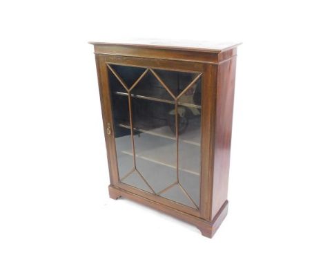 A Victorian mahogany display cabinet, the outswept pediment over a single glazed door, opening to reveal three shelves, raise